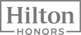 The image shows the Hilton Honors logo, featuring “Hilton” above “Honors” in a rectangular frame.